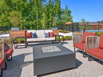 a patio with furniture and a fire pit